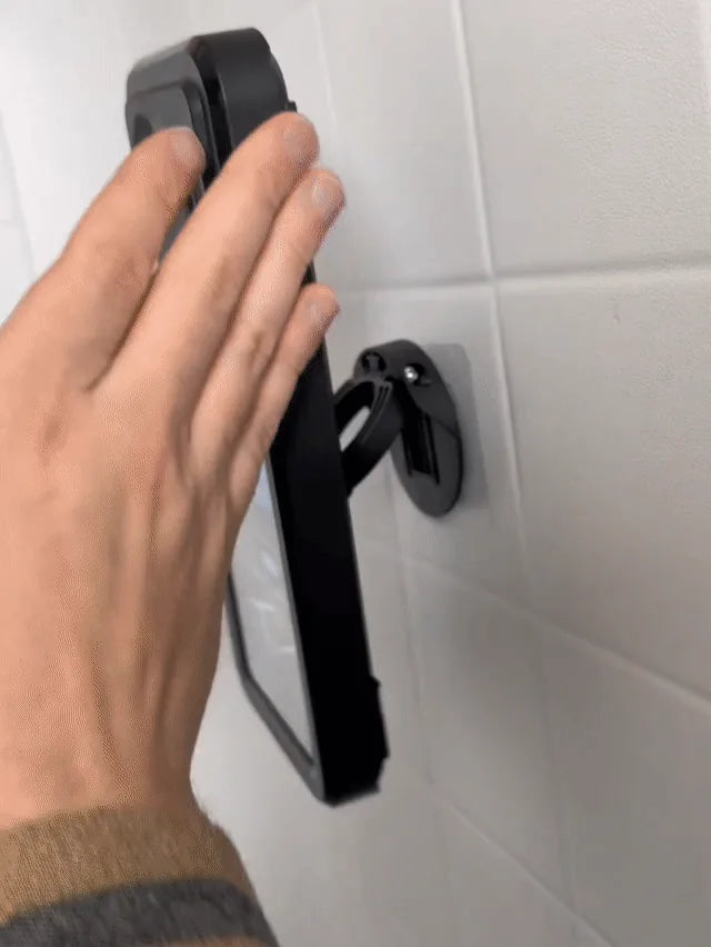 Actual adjustable shower phone case wall mount on a tiled bathroom wall